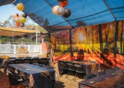 Party tent tables under hanging paper lanterns